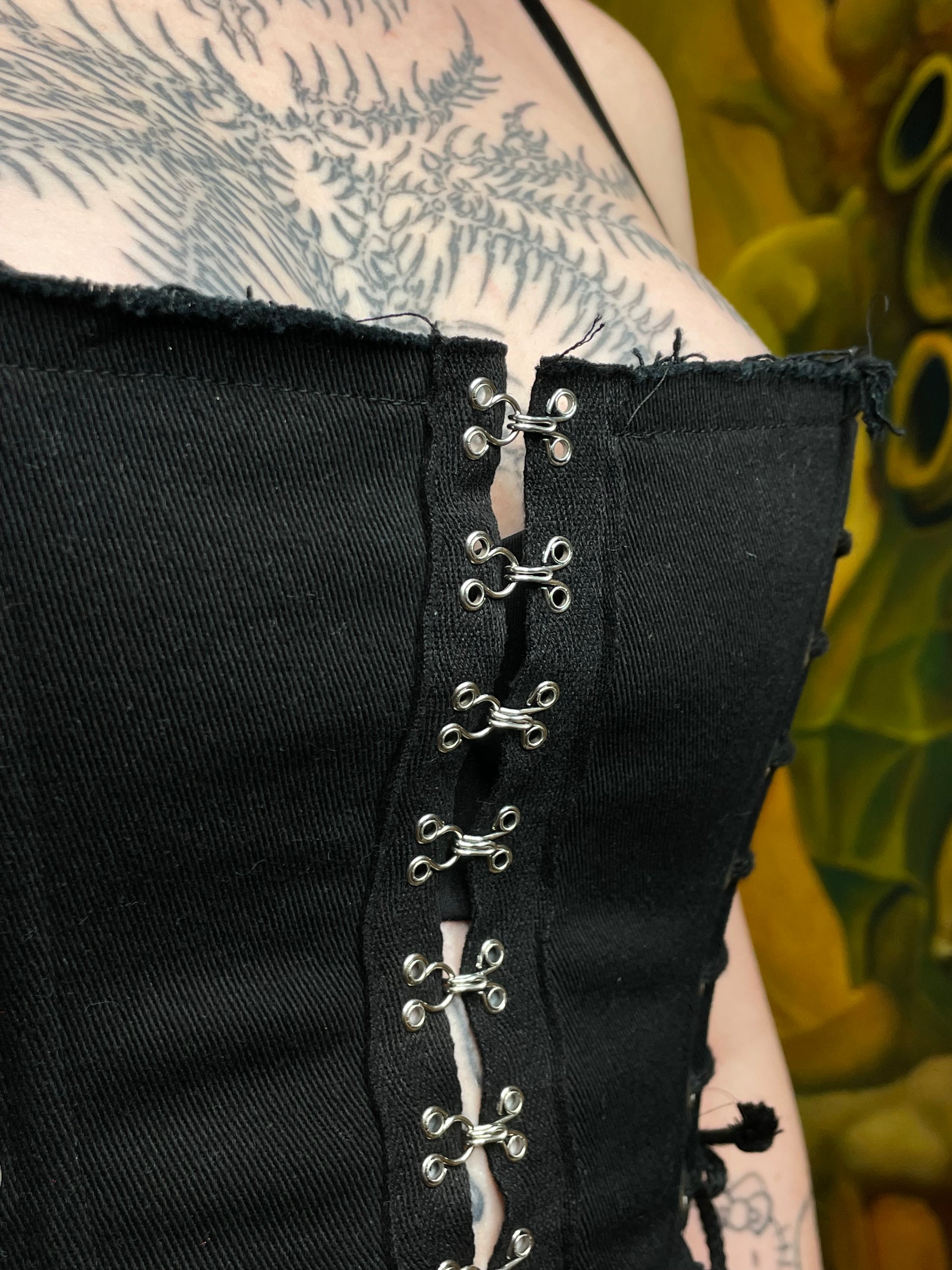 Close-up of black fabric with metal eyelets on a blurred background